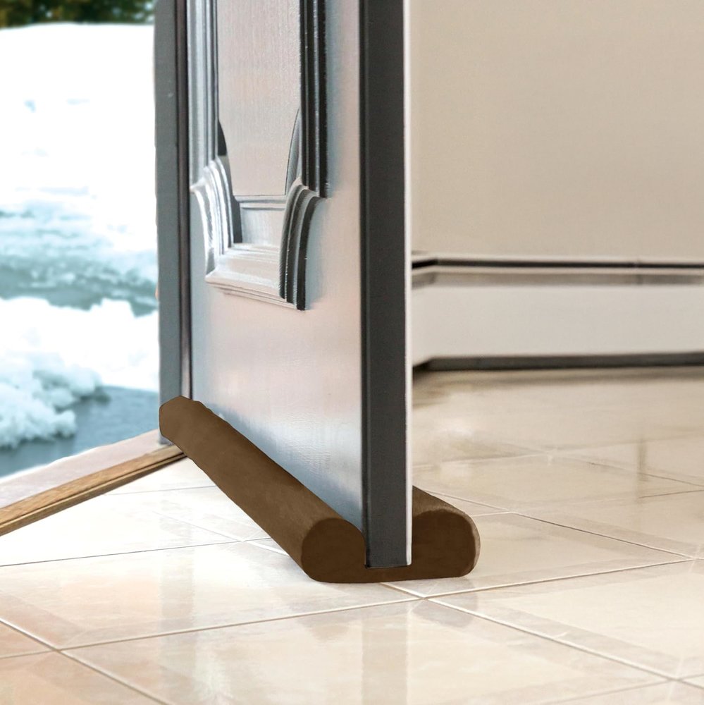Twin Draft Guard Hug N' Fit in brown under a gray front door on a tile floor